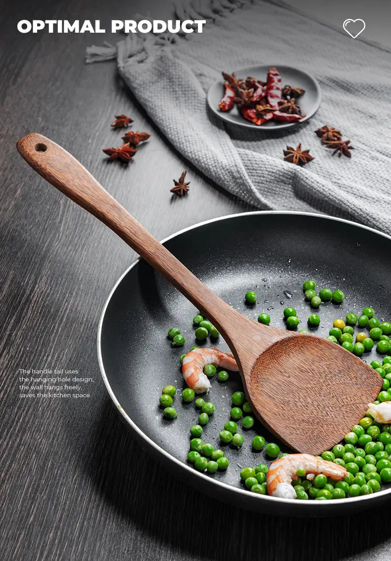 Wooden spatula with a smooth natural finish and a hole at the handle end for hanging in a wooden kitchen utensil set designed for non-stick cookware.