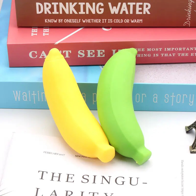 Two silicone banana toys slow rising stress relief toys in bright yellow and vibrant green shown from a front angle.