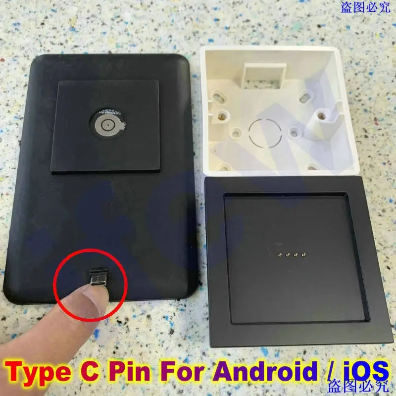 Black rectangular wireless charging pad with circular induction coil and type-c port for android ios devices integrated with tablet wall mount magnetic bracket for secure mounting.