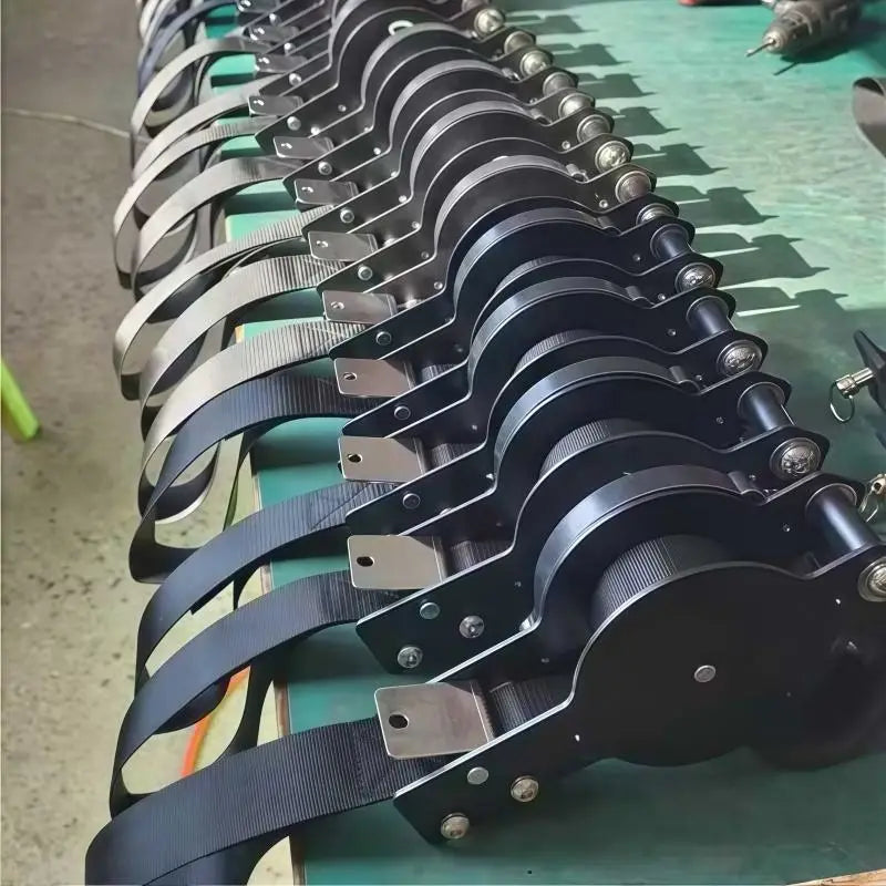 black fabric straps with metallic clamps and bolts arranged in a row for wooden gymnastics rings with numbered straps