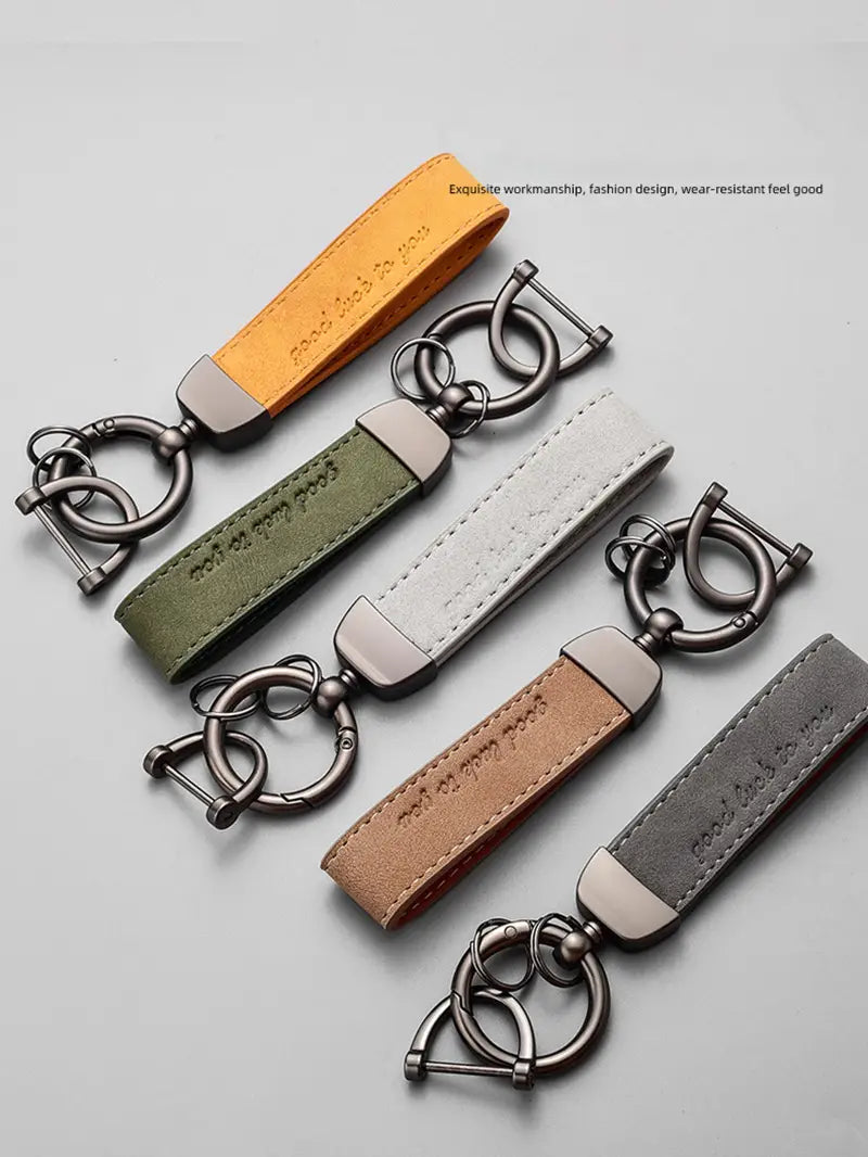 Five leather car keychain luxury genuine leather key rings in orange olive green white tan and gray with metallic hardware.