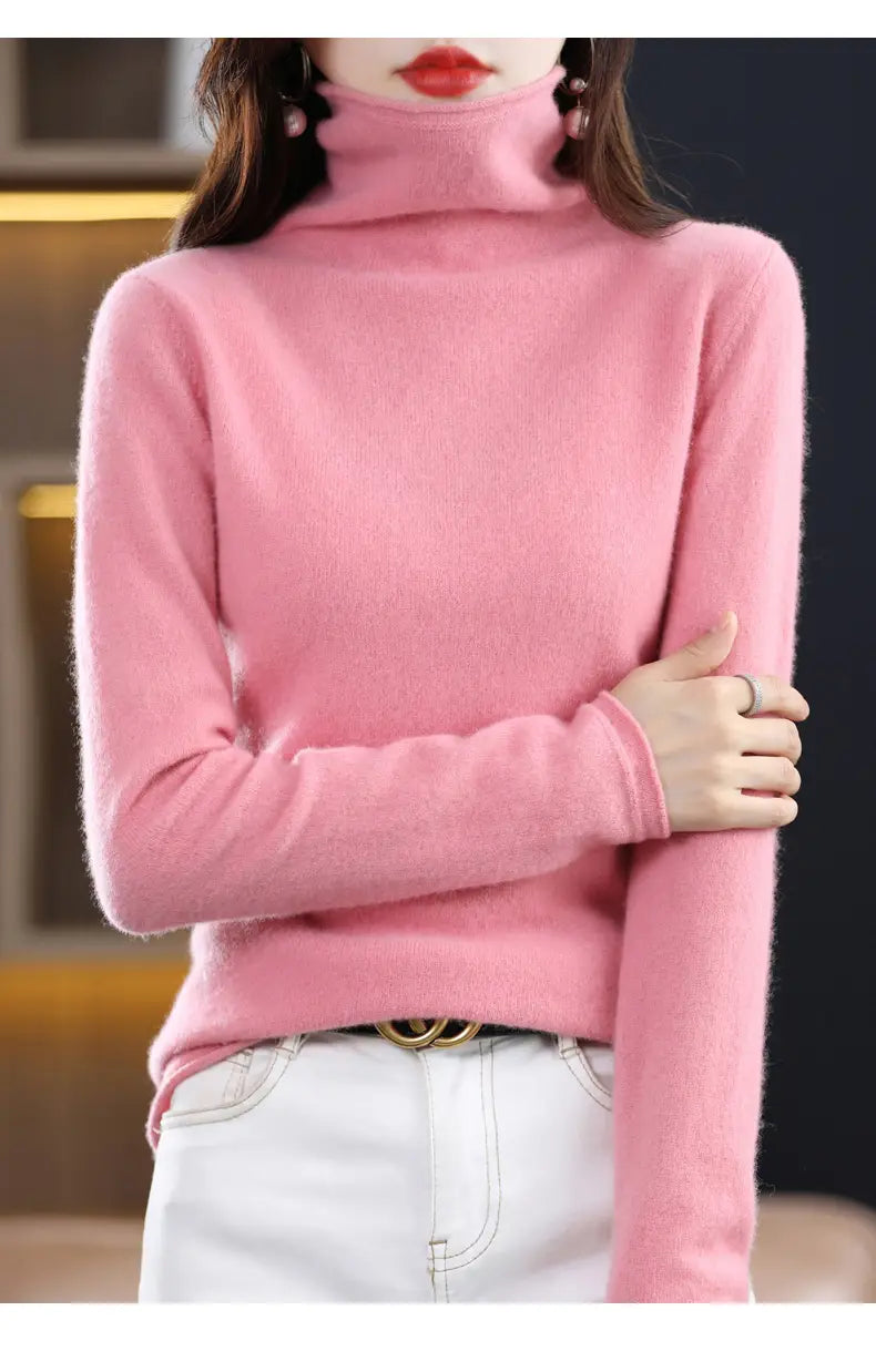 Pink merino wool turtleneck sweater for women with long sleeves made of soft plush material.