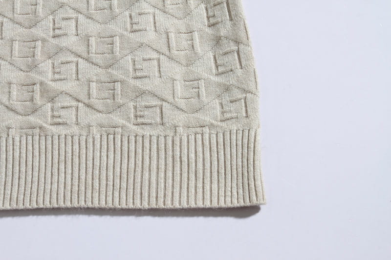 Plus size mens half zip cable knit sweater in beige featuring a repeating geometric pattern and ribbed hem.