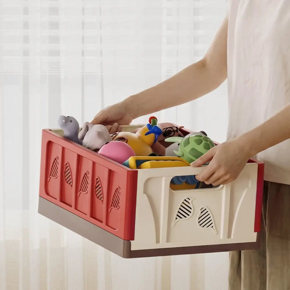 foldable storage basket plastic stackable organizer in red and beige with leaf-patterned cutouts showcasing actual goods and minimal chromatic aberration.