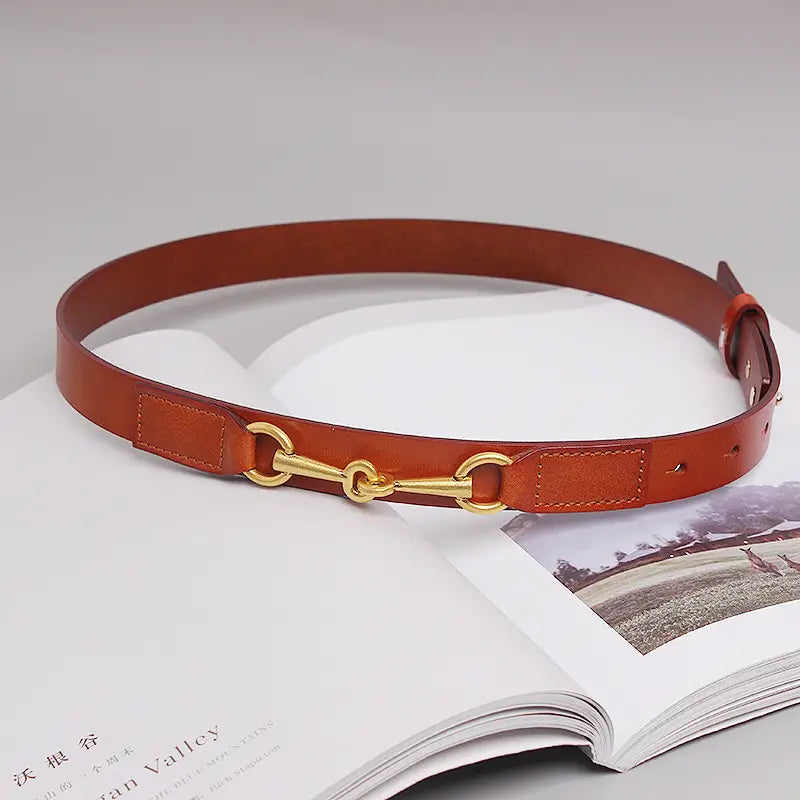 brown leather belt for women with a gold-toned horsebit buckle made of high-quality leather