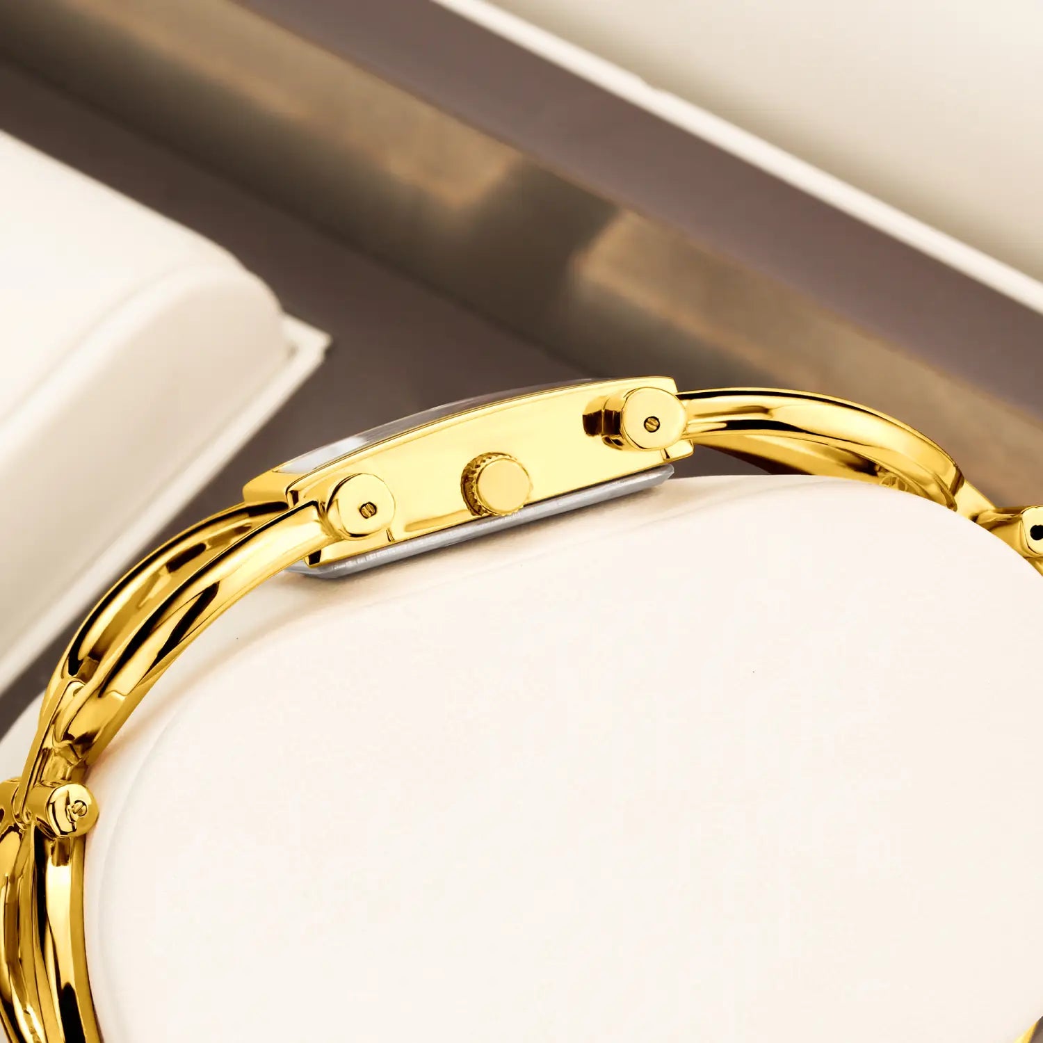Gold luxury quartz women watch bracelet featuring a gold-toned rectangular face with a sleek polished metal band and matching crown.
