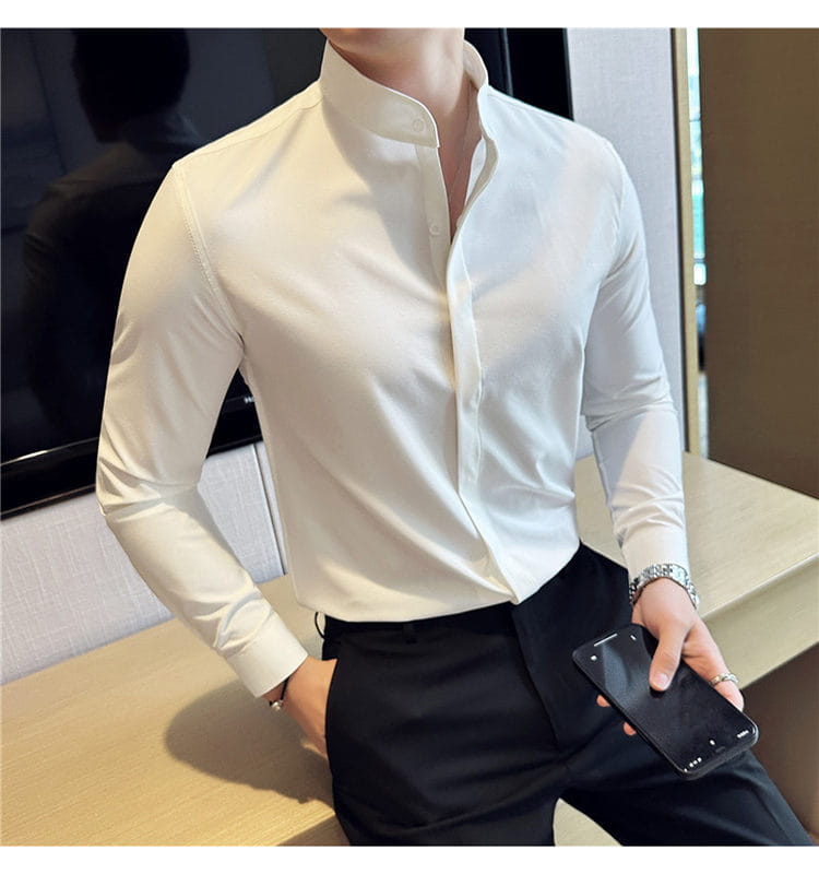 A crisp white slim fit men dress shirt with a stand collar and button-down front designed for a formal look and correct size.