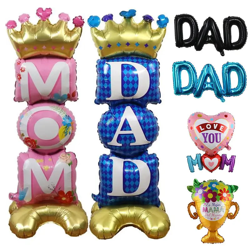 Mom dad crown balloon tower features pink and blue crown-themed balloon letters with floral patterns and gold bases.