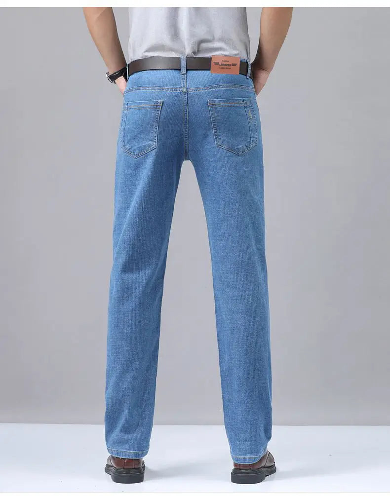 Light-wash blue men’s stretch cotton straight jeans with a classic straight-leg cut and rear pockets shown from the back, worn with a black belt.