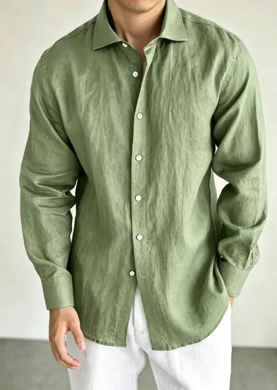 A men cotton linen casual button-down shirt in olive green featuring a classic collar and white buttons.