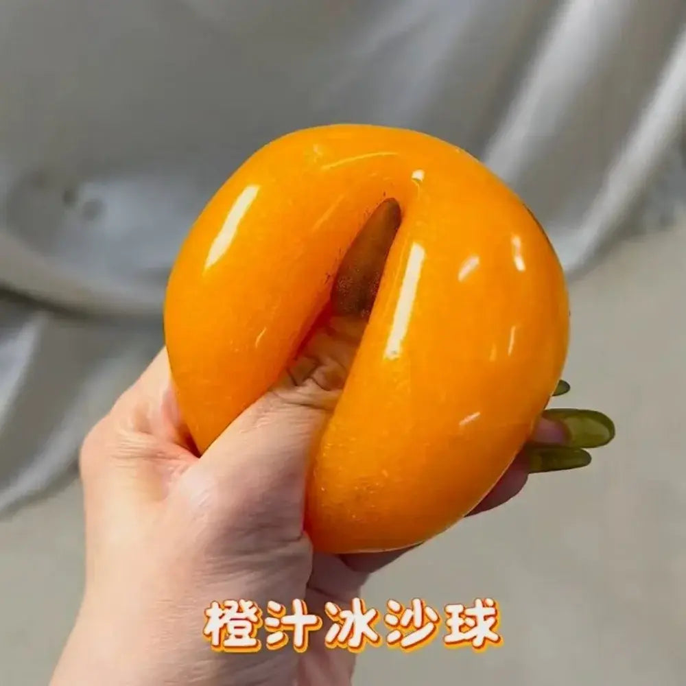 A vibrant orange slushy squishy stress relief toy shaped like a glossy donut with a central hole shown from the front.