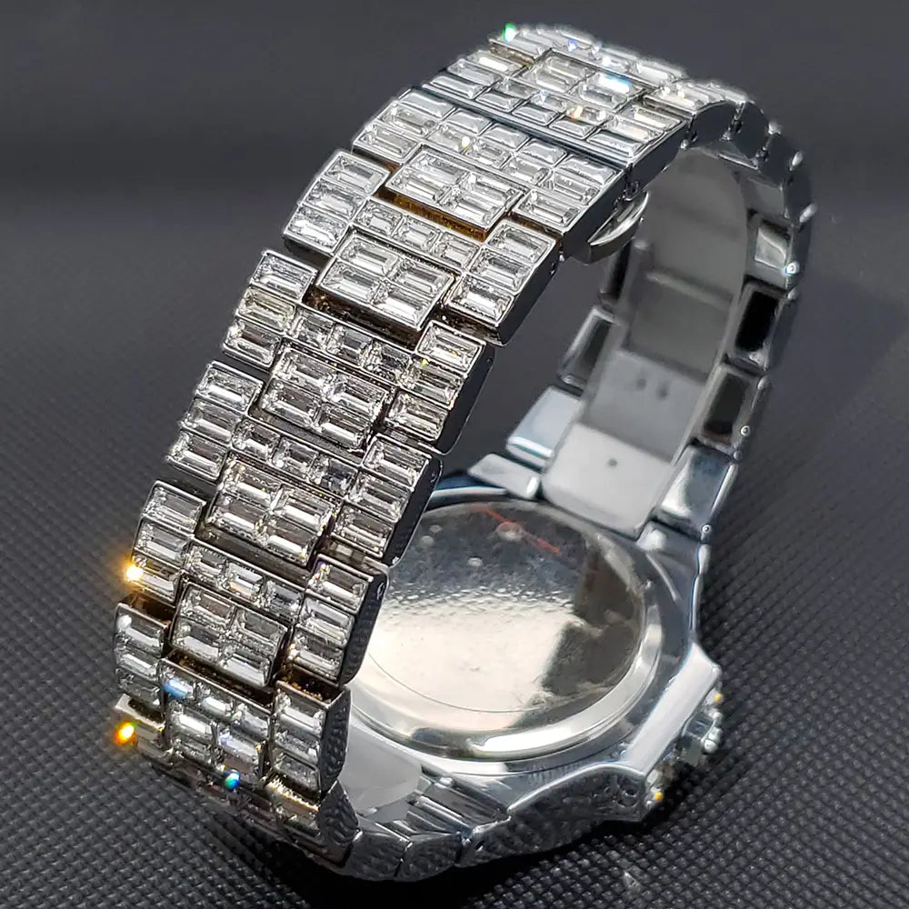 Silver stainless steel iced out diamond quartz watch for men with a silver-toned watch band featuring baguette-cut clear crystals set in a metallic link design.