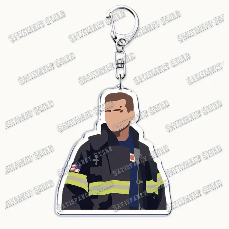 Clear acrylic 9-1-1 Tv Show keychain featuring a stylized firefighter illustration in black turnout gear with yellow reflective stripes and an American flag patch attached to a silver metal clasp.
