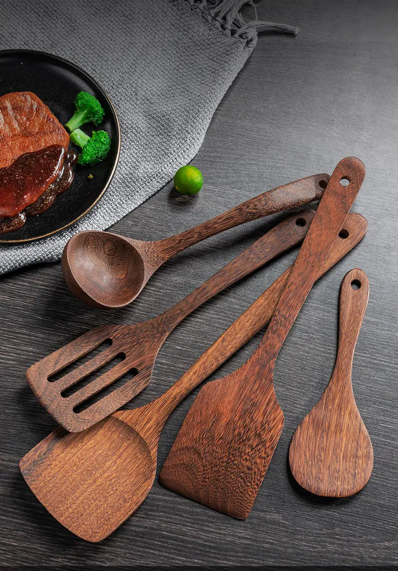 Set of five dark brown wooden kitchen utensils with natural wood grain and rounded handles designed for non-stick cookware.