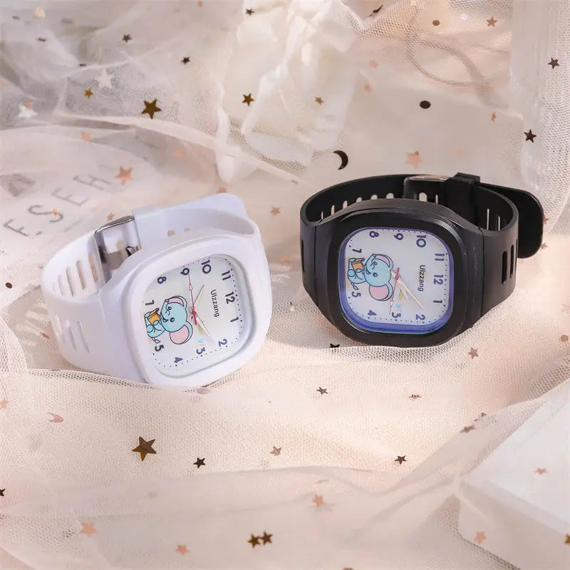 Two children’s luminous digital wristwatches in white and black featuring a square face with cartoon elephant designs for kids.