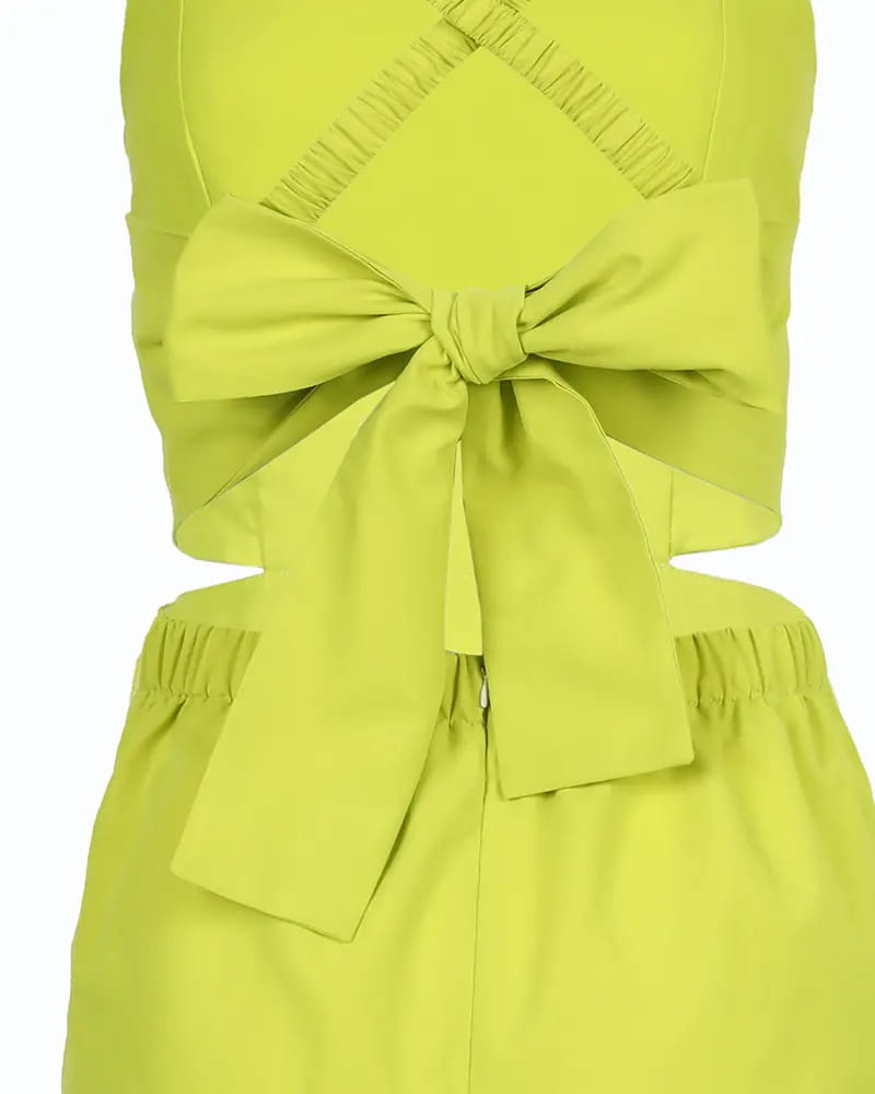 A vibrant lime green women summer printed cutout jumpsuit featuring a back view of a cropped top with a large bow and matching high-waisted pants.