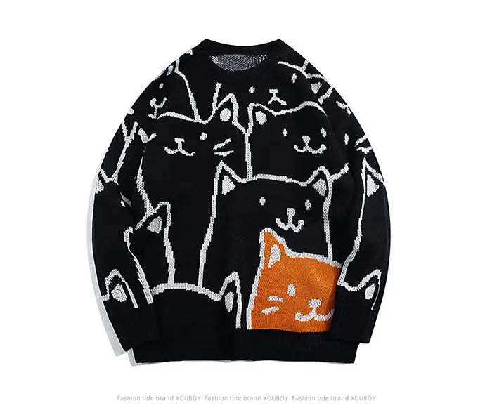 Pull ample en maille noire, avec un motif ludique de chats aux contours blancs et un chat orange bien visible sur la partie avant basse, inspiré du style Cartoon Cat Harajuku.