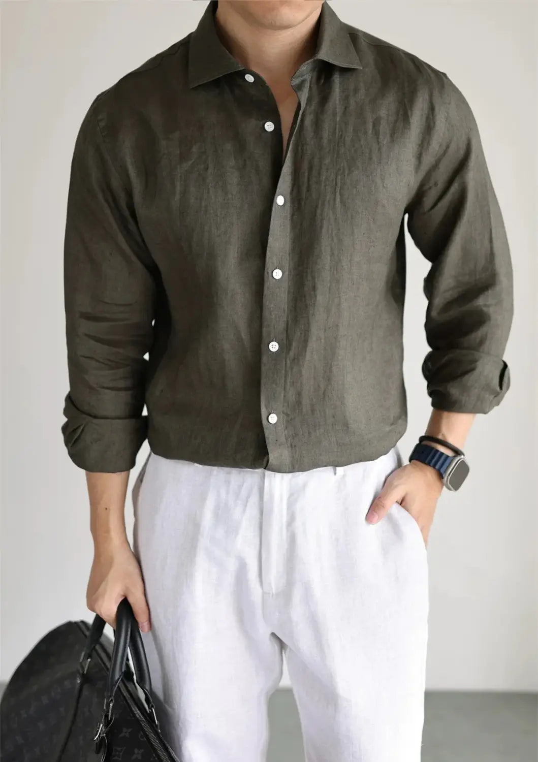 Men cotton linen casual button down shirt in olive green with white buttons and rolled up sleeves made from breathable linen fabric.
