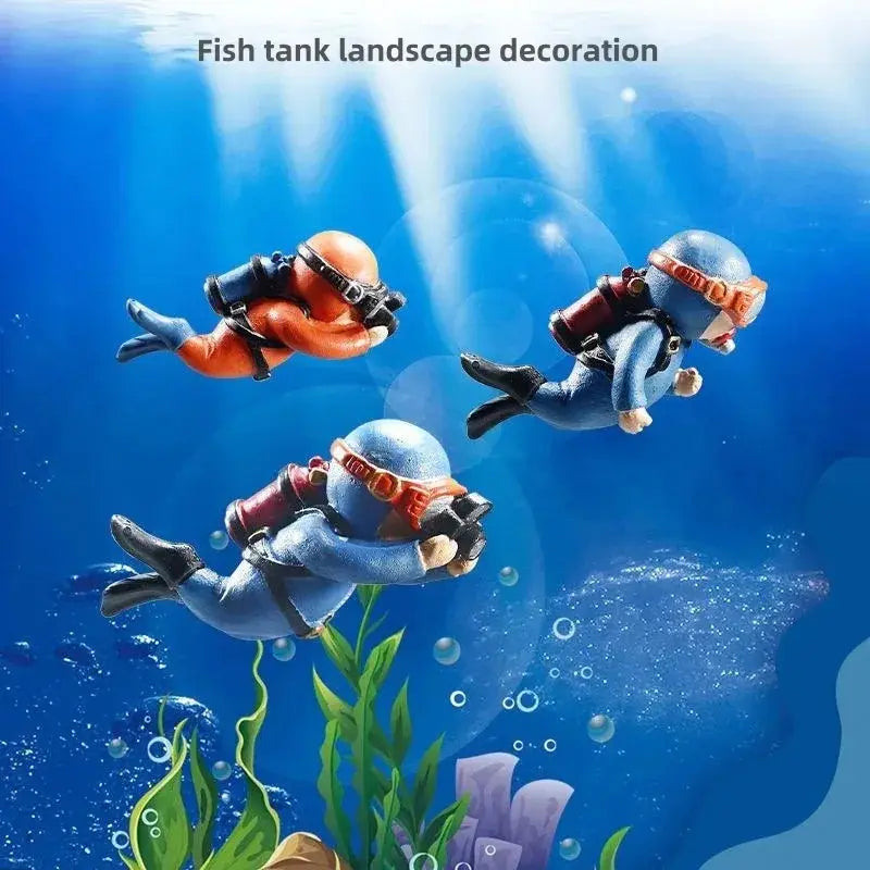 three miniature scuba diver aquarium decorations in orange and blue suits with detailed gear and fins for fish tank landscape decor accessories and gifts for aquatic pets.