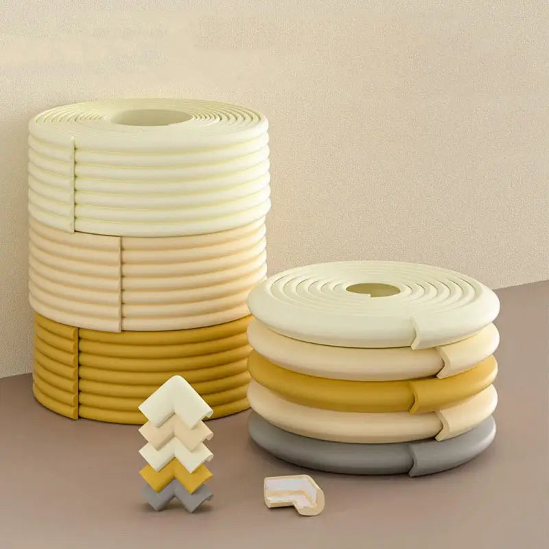 Stacks of soft foam baby safety edge protector strips in cream and yellow hues designed for child safety and cushioning sharp corners.