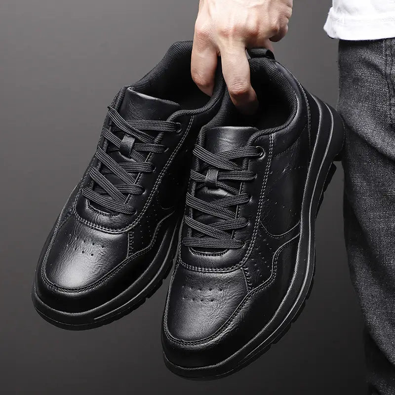 Men black leather chunky sole sneakers featuring a sleek minimalist design with matching laces.