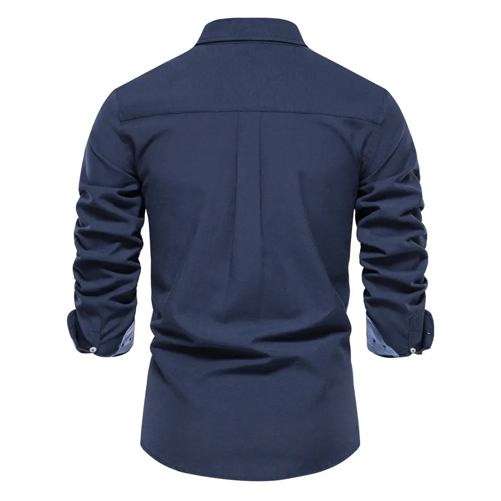 Dark navy blue long-sleeved men dress shirt with contrasting light blue inner cuffs and subtle pleated back design ideal for fashion social shirts and dress shirts.