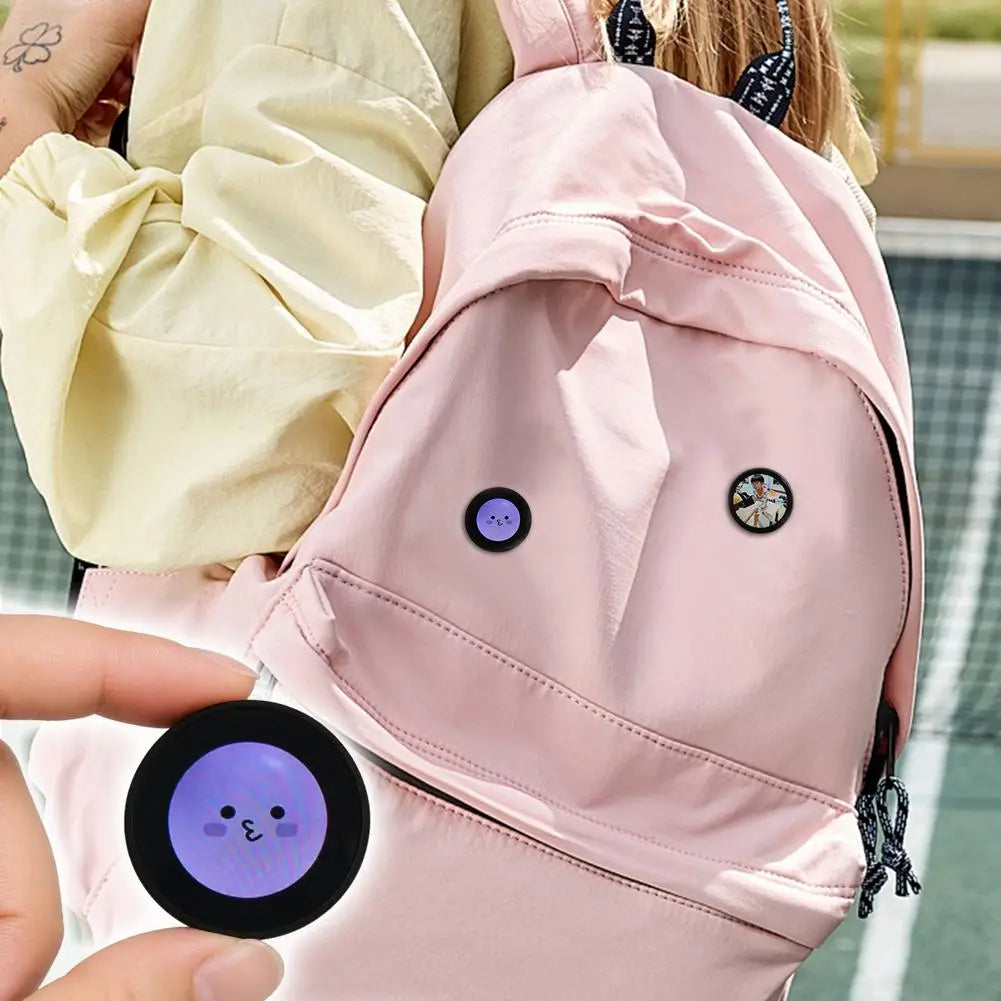 A cute round purple mini gadget smart desktop companion with a smiling face design and included data cable.