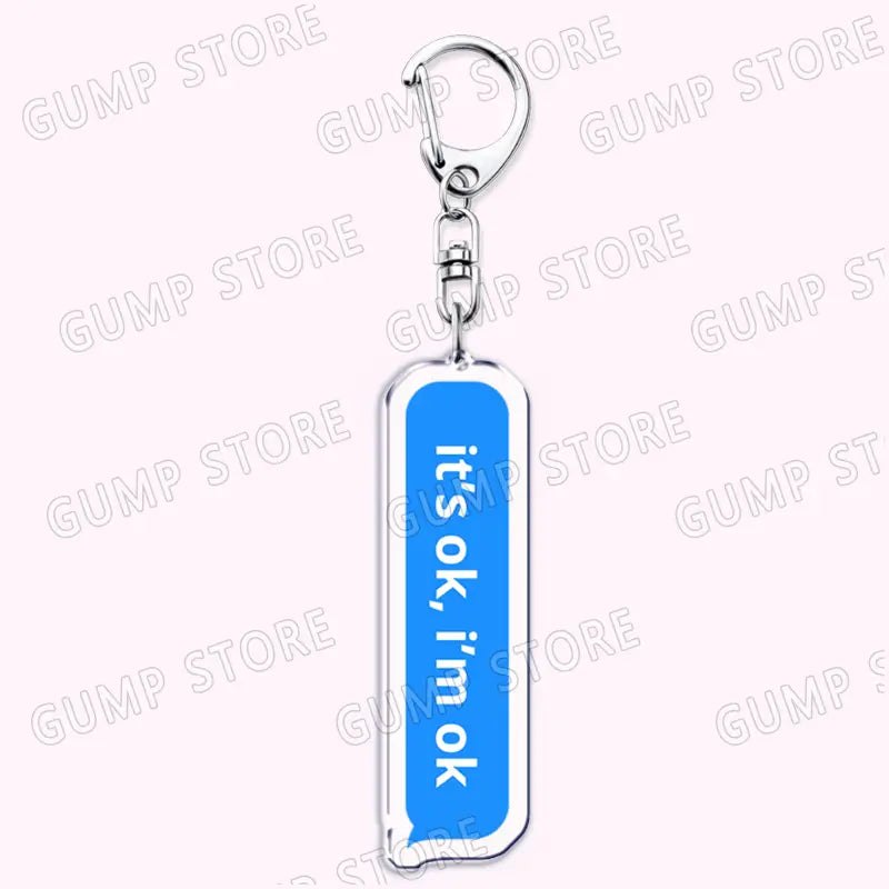 silver-accented acrylic keychain with a blue rectangular charm featuring the text its ok im ok designed as a Tate Mcrae music fan gift.