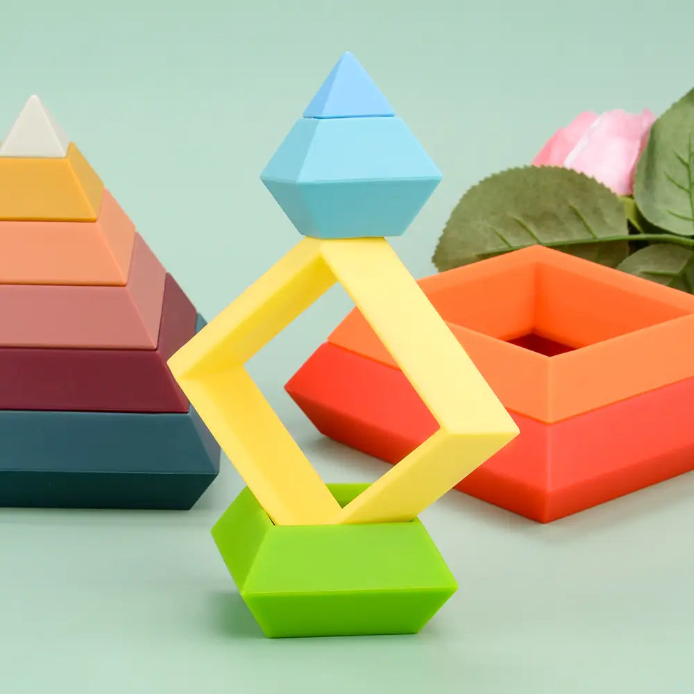 Silicone stacking blocks pastel Montessori toys featuring a vibrant geometric stacking design with layered pyramid and square shapes in pastel blue bright yellow and lime green.