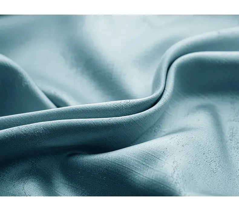 a soft light blue fabric with a subtle textured weave and gentle folds for living room curtains custom blackout drapes para la sala featuring tassel tieback beads