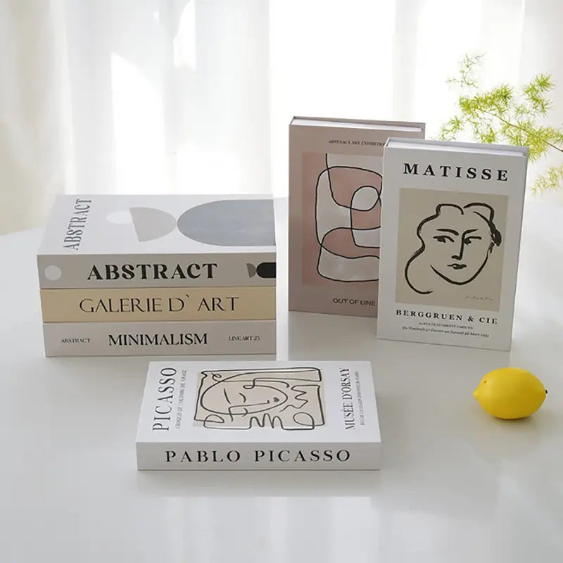 White rectangular decorative fake book with black line art of a face and bold uppercase matisse text for coffee table home decor.