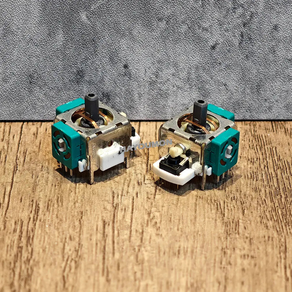 Ps2 analog stick joystick replacement with teal and silver thumbsticks and white plastic components designed for precise gaming control.