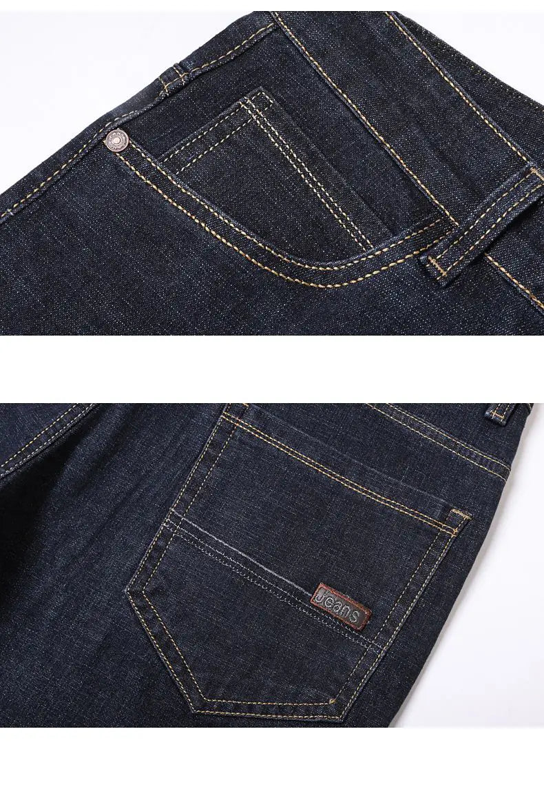 Dark blue denim men’s stretch cotton straight jeans with contrasting white stitching and a small brown leather patch on the back pocket shown from the back side.