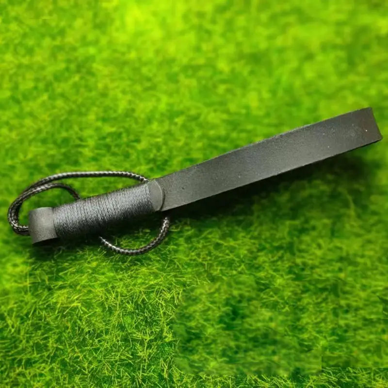 Black leather weave lanyard keychain car key holder with textured buckle grip and braided cord loop.