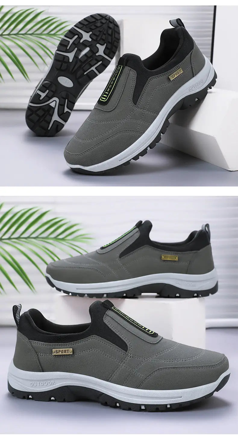 Men orthopedic slip-on walking shoes in gray and black with a white midsole, textured rubber outsole, and a gold-colored brand tag on the side.