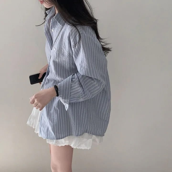 light blue and white vertically striped cotton blouse with relaxed fit featuring long sleeve design and standard thickness for versatile style.