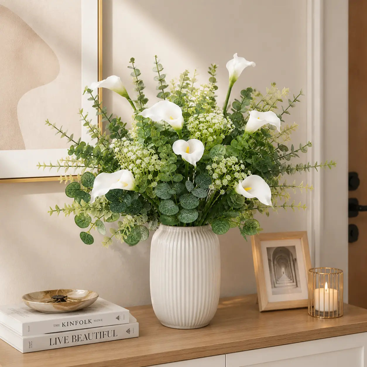 A white ribbed ceramic vase holding a lush arrangement of artificial mixed flowers featuring calla lilies and greenery from the mixed flowers 48pcs wedding bouquet set.