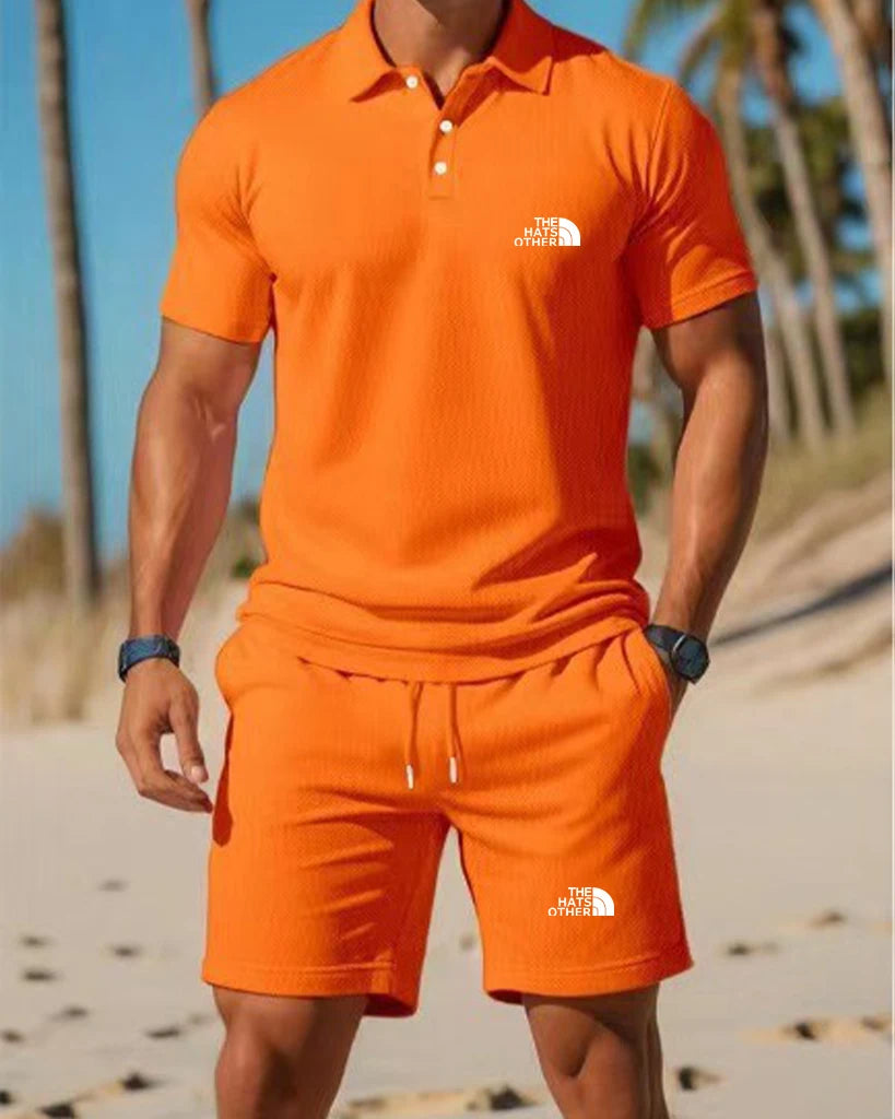Men’s knit polo and shorts set featuring a vibrant orange short-sleeved polo shirt with a classic collar button placket and The North Face logo on the chest.