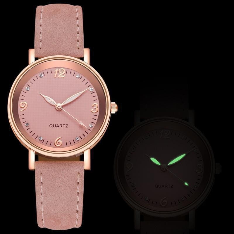 A women quartz watch with a rose gold dial, delicate rose gold-tone case, soft pink suede leather band, and diamond-like hour markers.