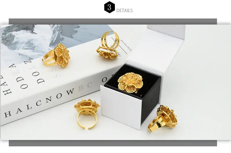 gold plated 24k gold dubai jewelry spiral rings for women featuring an intricately designed flower shape with a metallic finish
