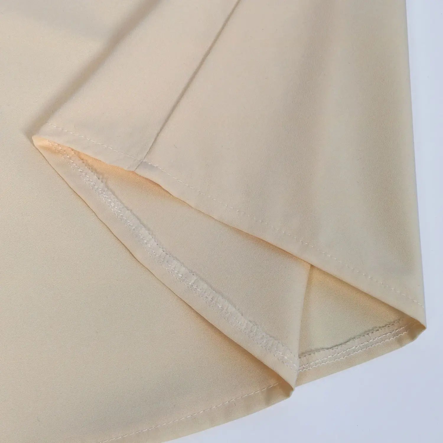 Beige fabric detail with neat matching stitching along the folded edge of a mens pirate medieval renaissance lace up shirt by Arba Global.