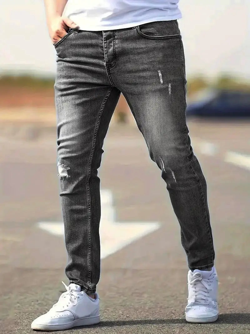 men distressed skinny jeans made of dark gray distressed denim featuring ripped knee details in a vintage slim fit style