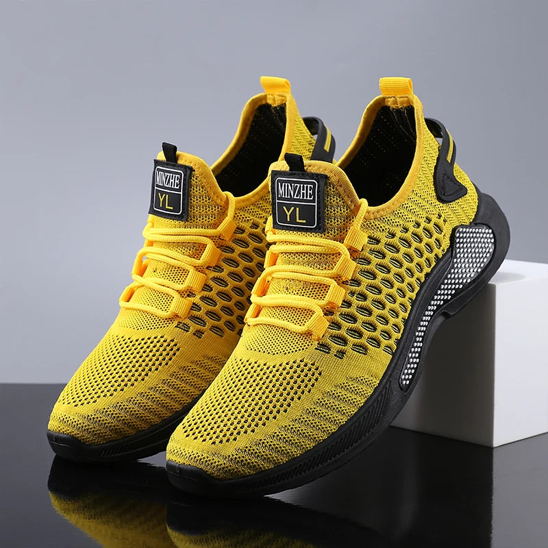 Men breathable slip-on mesh sneakers in bright yellow with black accents and a textured rubber sole featuring a branded label on the tongue.