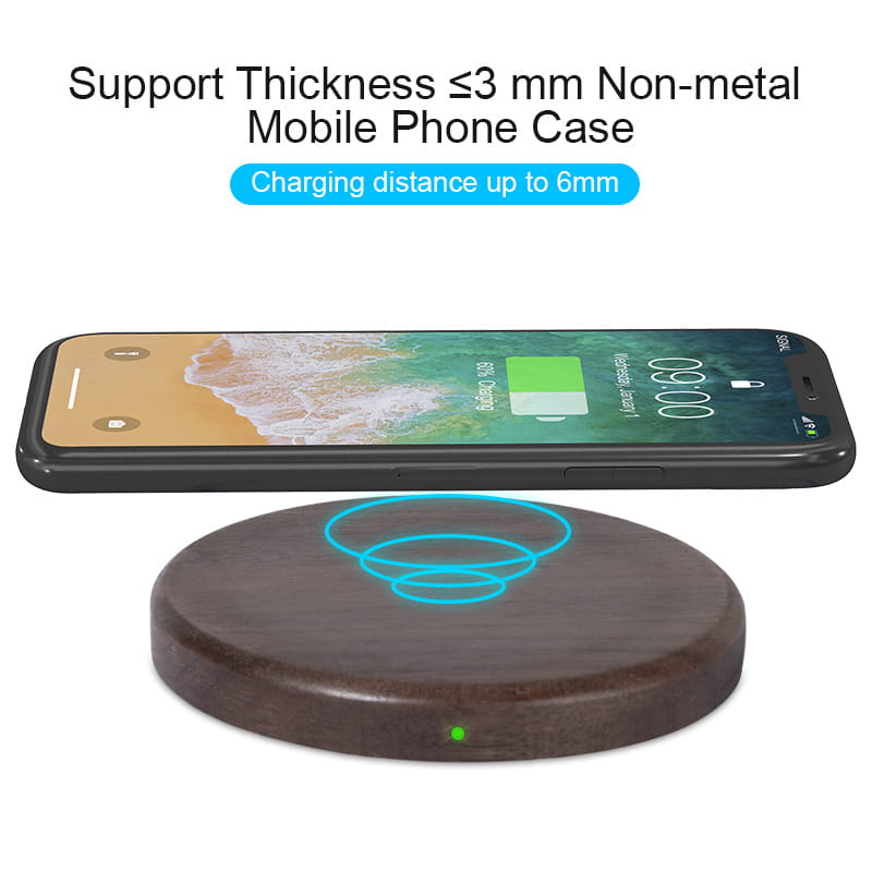 dark wood circular walnut wood wireless charging pad 15w with glowing blue charging symbol and green indicator light
