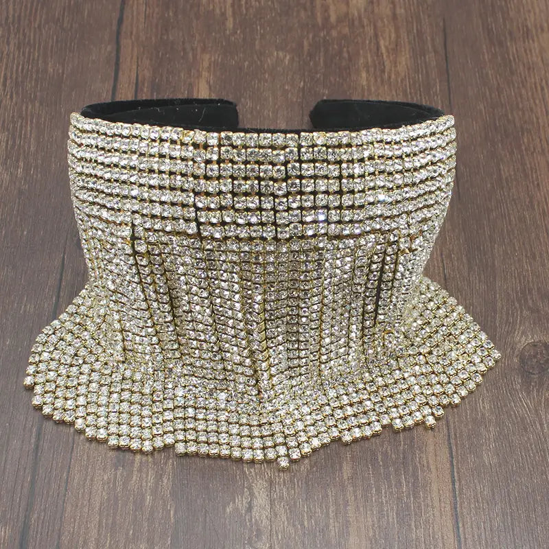 Bandeau en perles et strass orné d’un ras-de-cou en strass doré scintillant, d’un design dégradé évasé et d’un intérieur en velours noir, pour une tenue de mariée élégante.