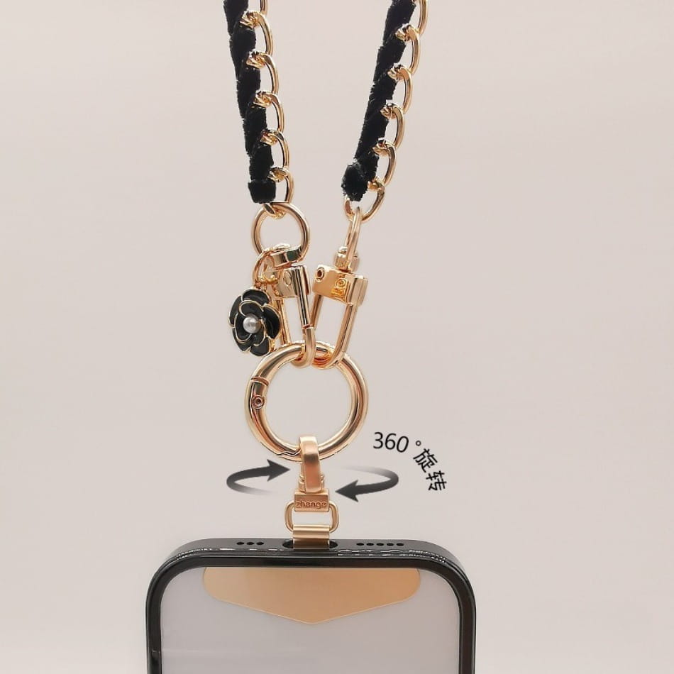 Goldfarbener Handy-Handgelenkriemen mit schwarzem geflochtenem Kord und dekorativem schwarzem Blumencharm, entworfen als Anti-Lost-Handylanyard.