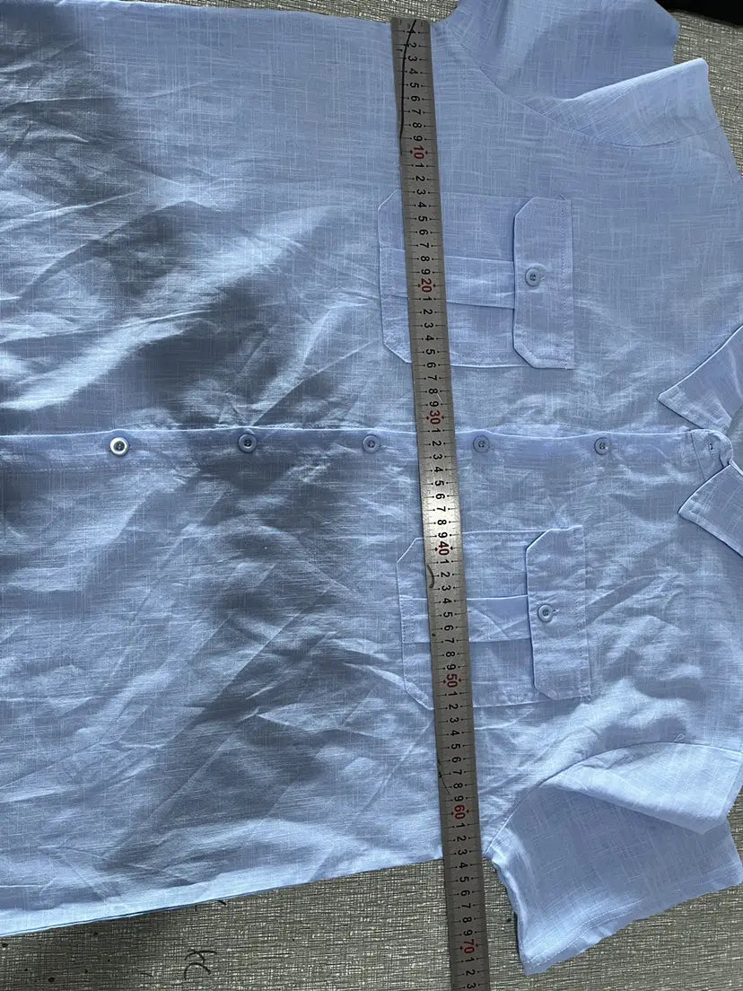 Light blue men linen short sleeve shirt with a subtle woven texture and double chest pockets suitable for casual summer wear.