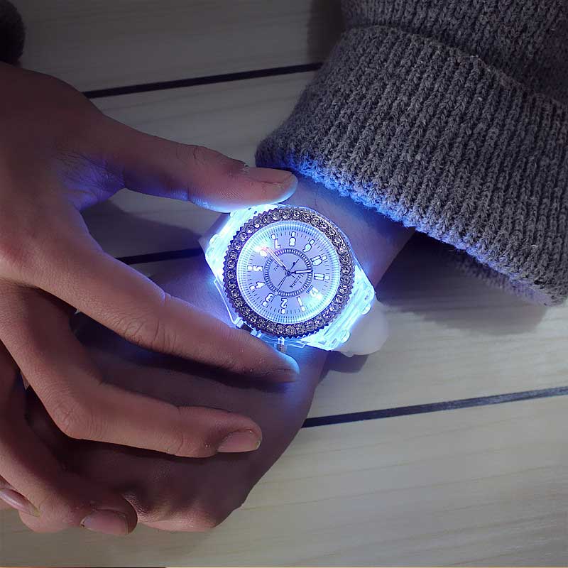 A glowing translucent white led luminous silicone watch with a sparkling blue and silver rhinestone-adorned bezel digital timepiece.