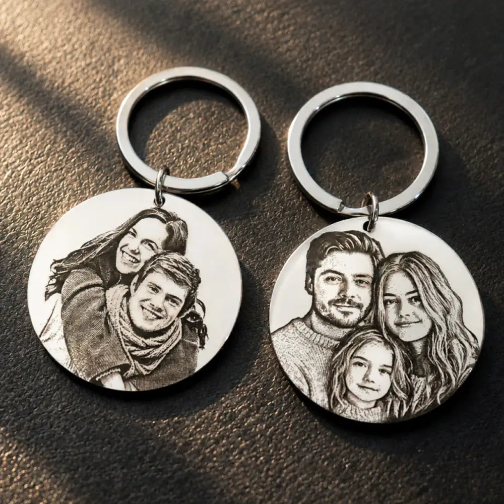 silver circular custom photo keychain stainless steel round pendant featuring intricately engraved black-and-white portrait sketches of families