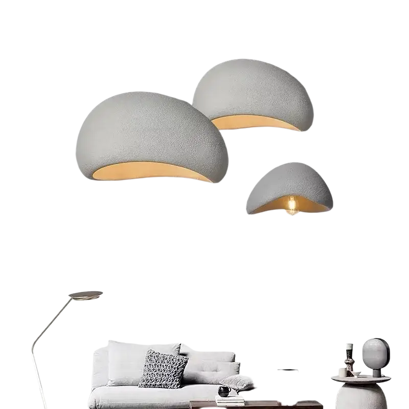 Three matte gray pendant lights with textured surfaces and warm lighting for living room and dining room use